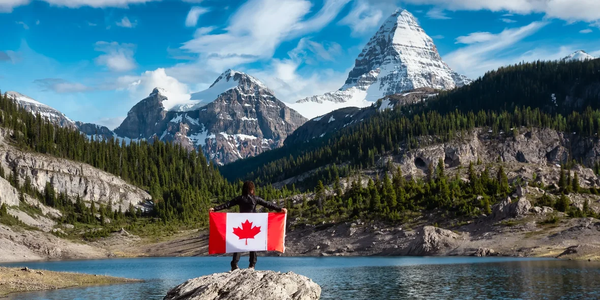 The flag of Canada against the backdrop of the Canadian landscape