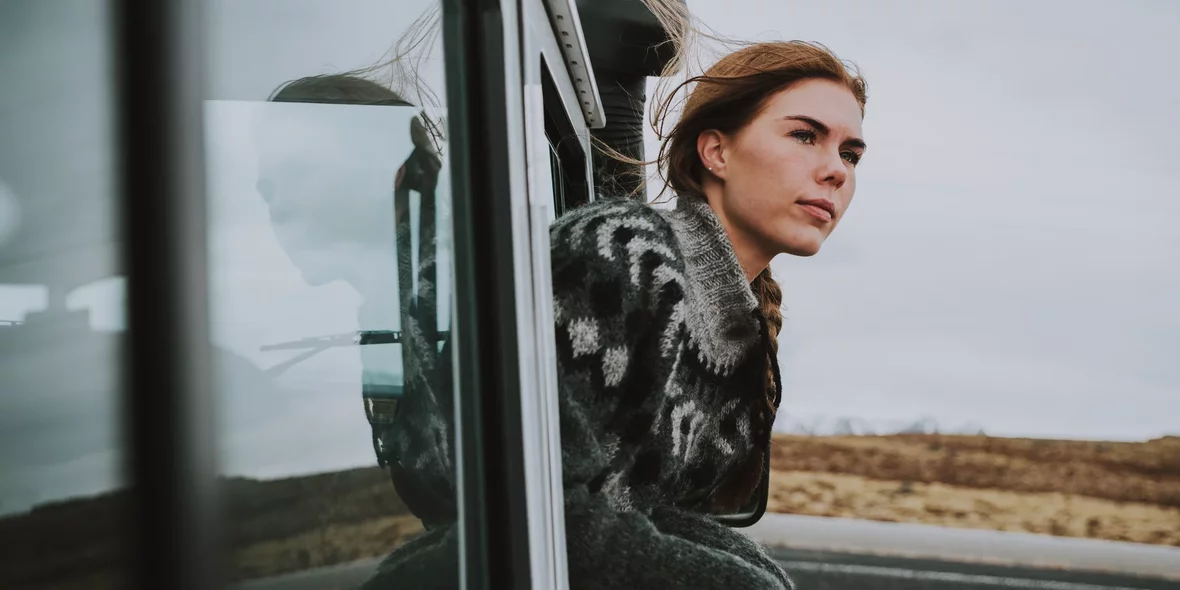 A girl looks out of a car window in Iceland