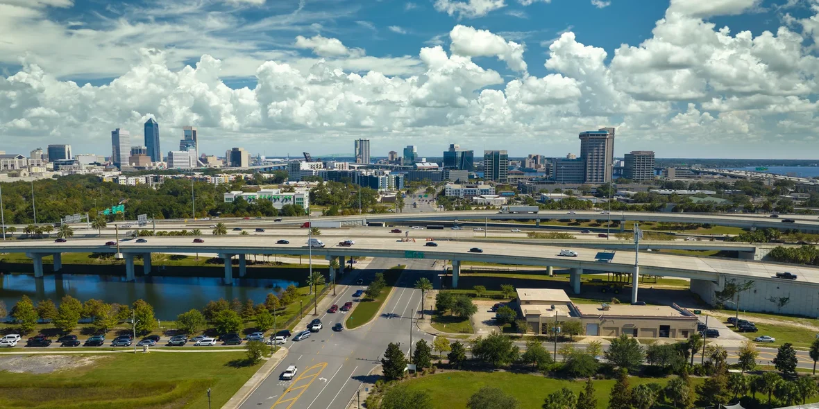 An aerial view of the city of Jacksonville with tall office buildings and the U.S. Freeway