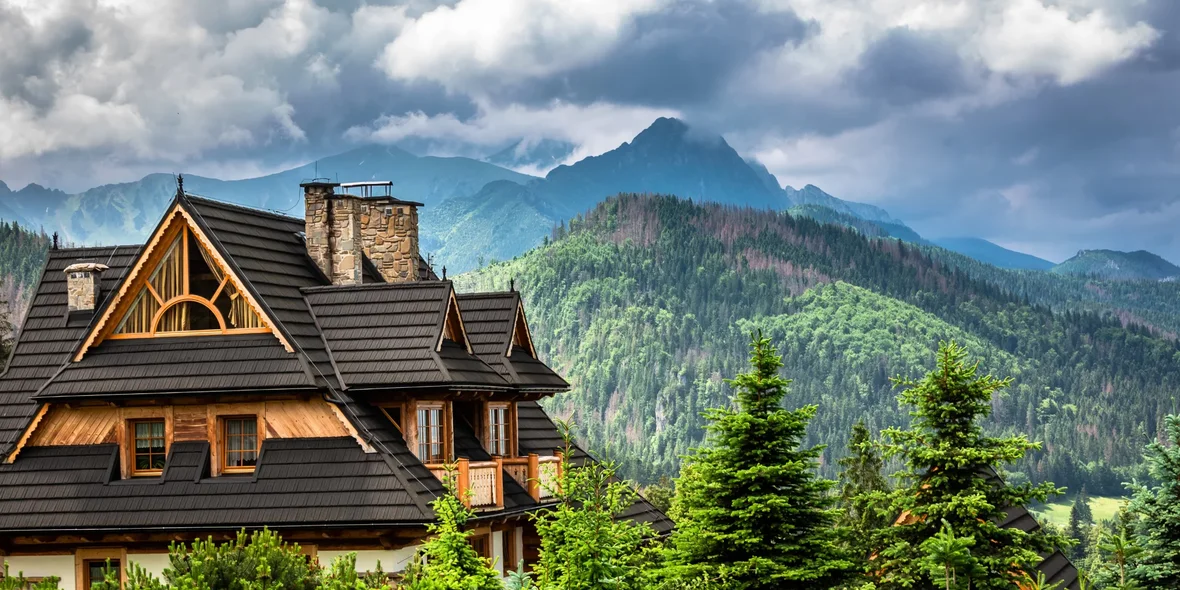 A wooden cottage and clouds over the Tatra Mountains in Poland