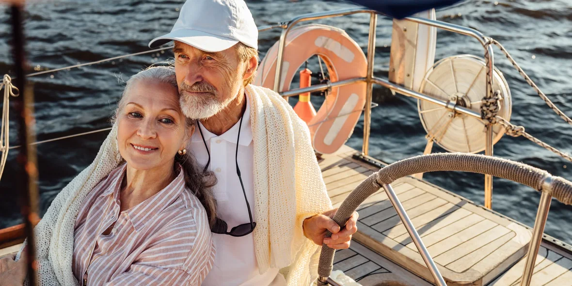 Older people are enjoying a sailing boat ride