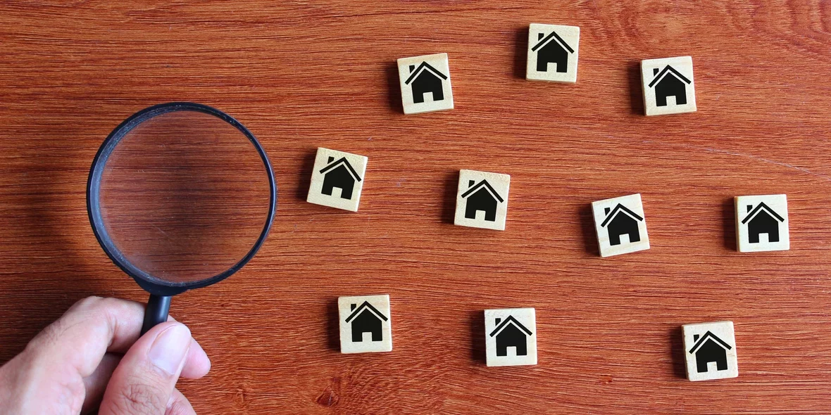 Cubes with house sign and magnifying glass