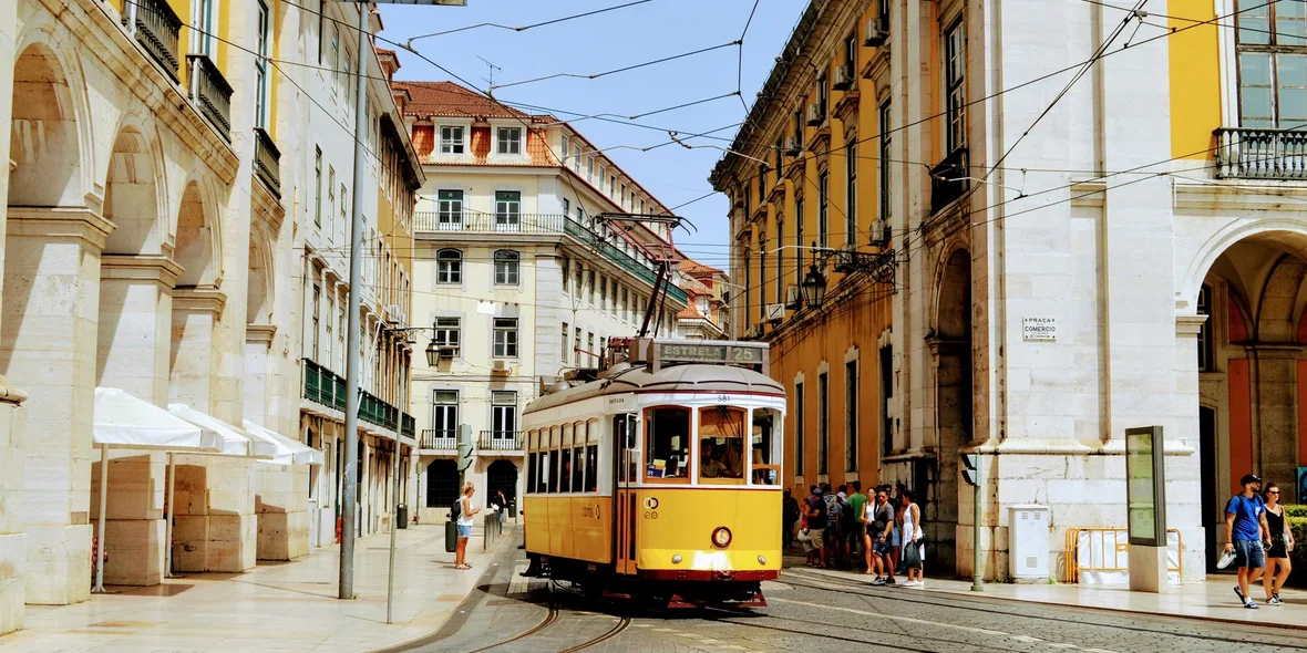 A colourful tram on a narrow street in Portugal