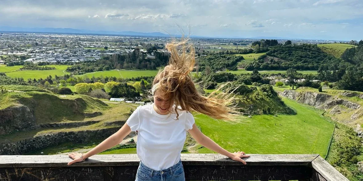 A girl in New Zealand, hair fluttering in the wind.