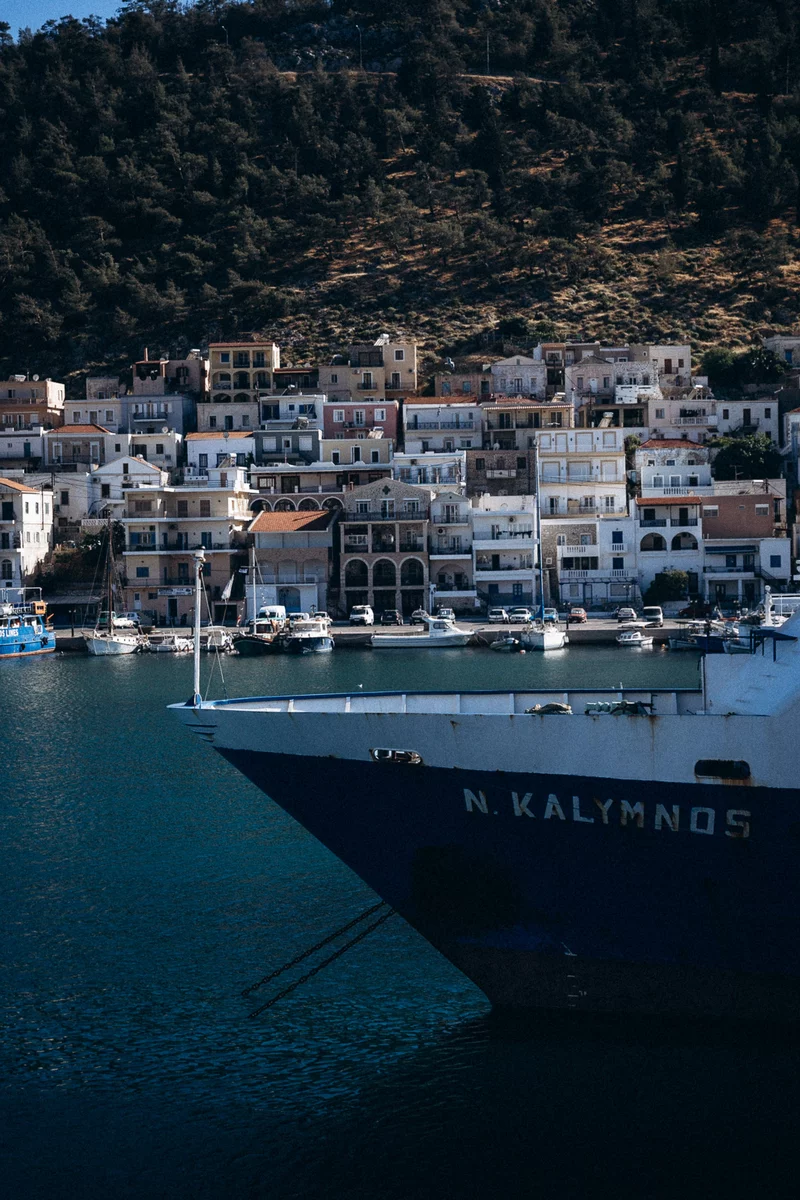 view of houses in Greece and a ship at sea