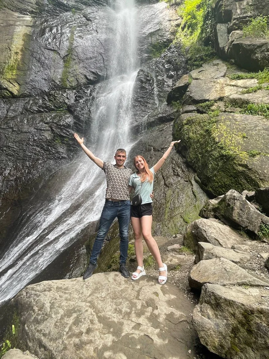 couple in front of a waterfall