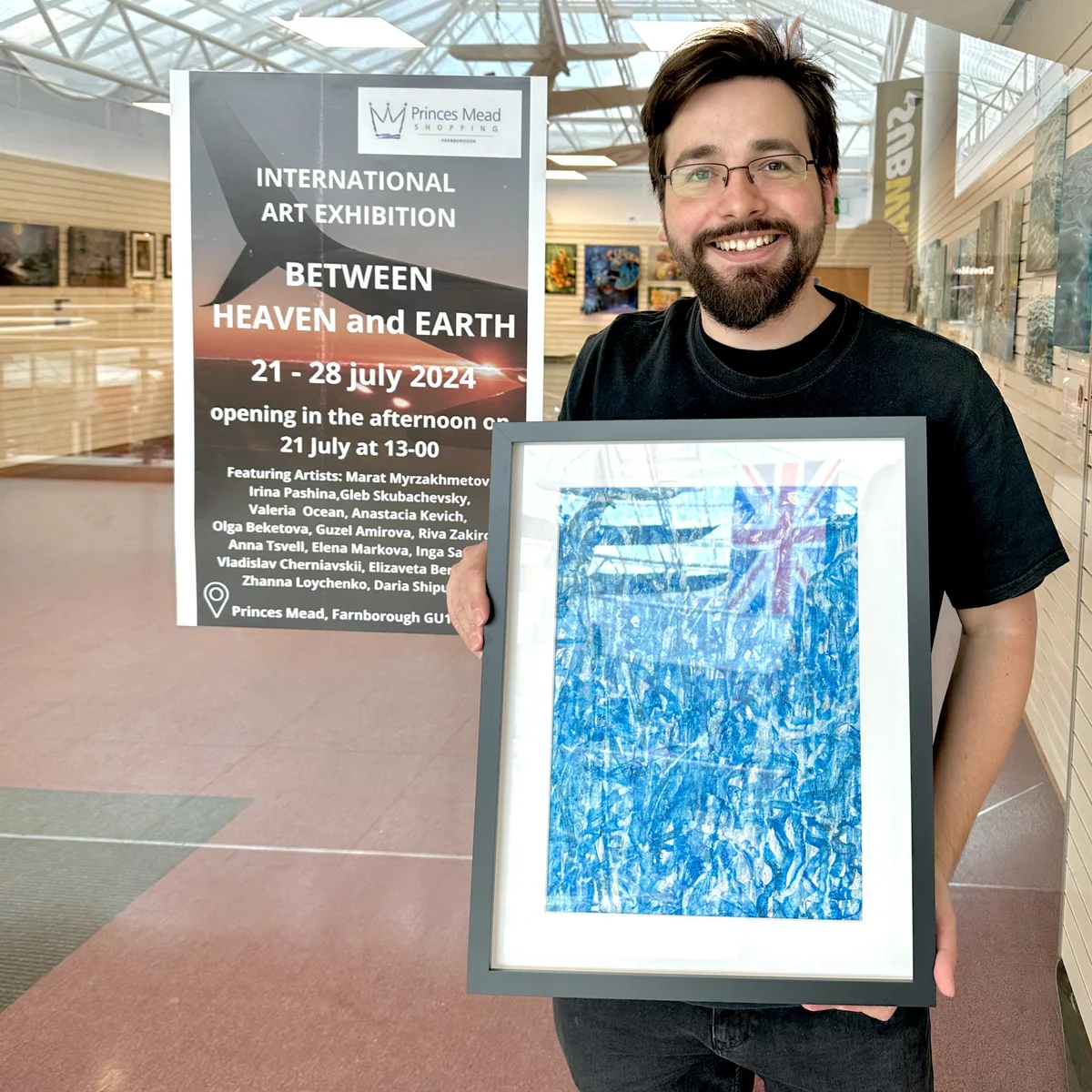 joyful Gleb Skubachevsky with a painting in his hands