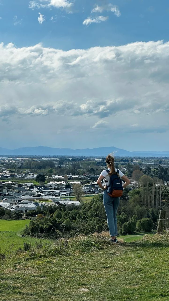 a girl looks at a panorama of a city in New Zealand.