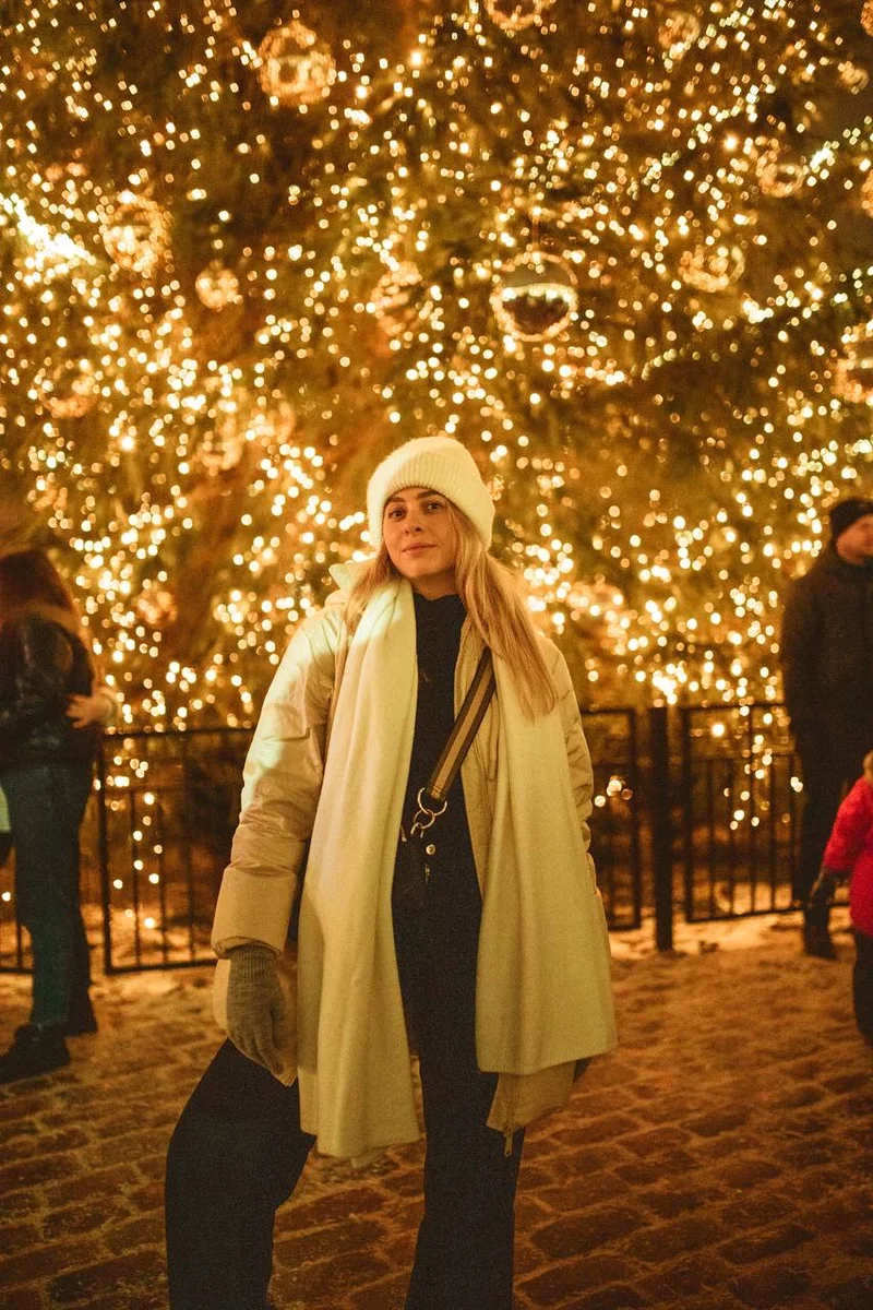 girl against the Christmas tree