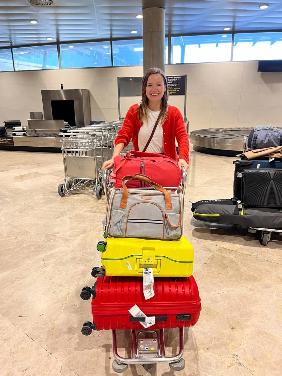 smiling girl with suitcases 