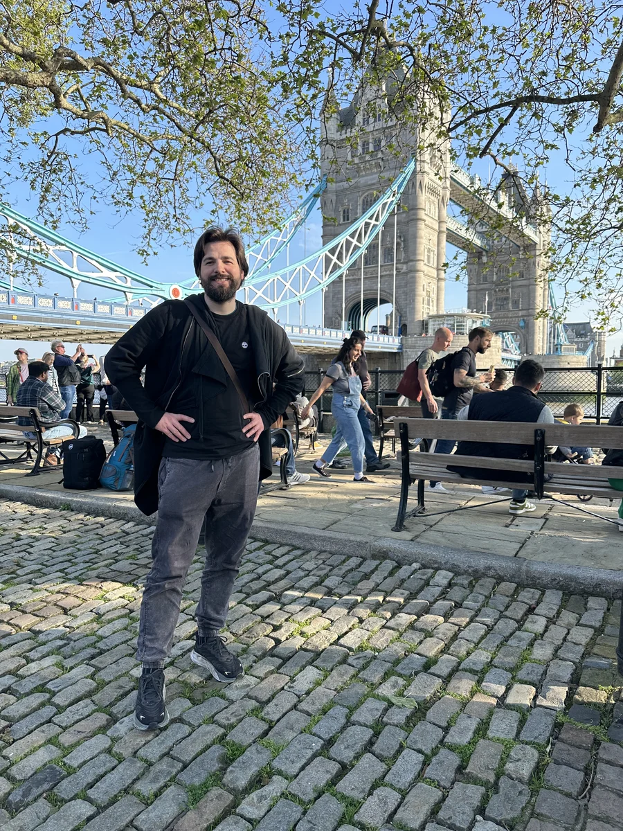 a male artist and Tower Bridge.