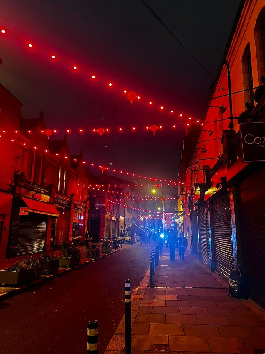 A bustling bar street at night in Dublin.