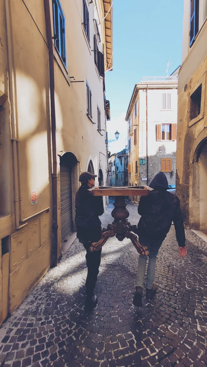 A couple carrying a table