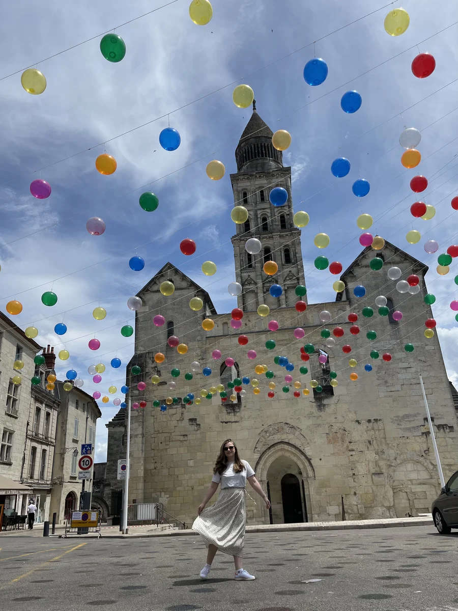 A girl in front of a landmark in France