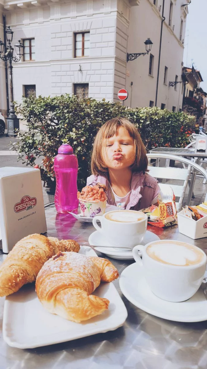 A girl eating pastries in Italy