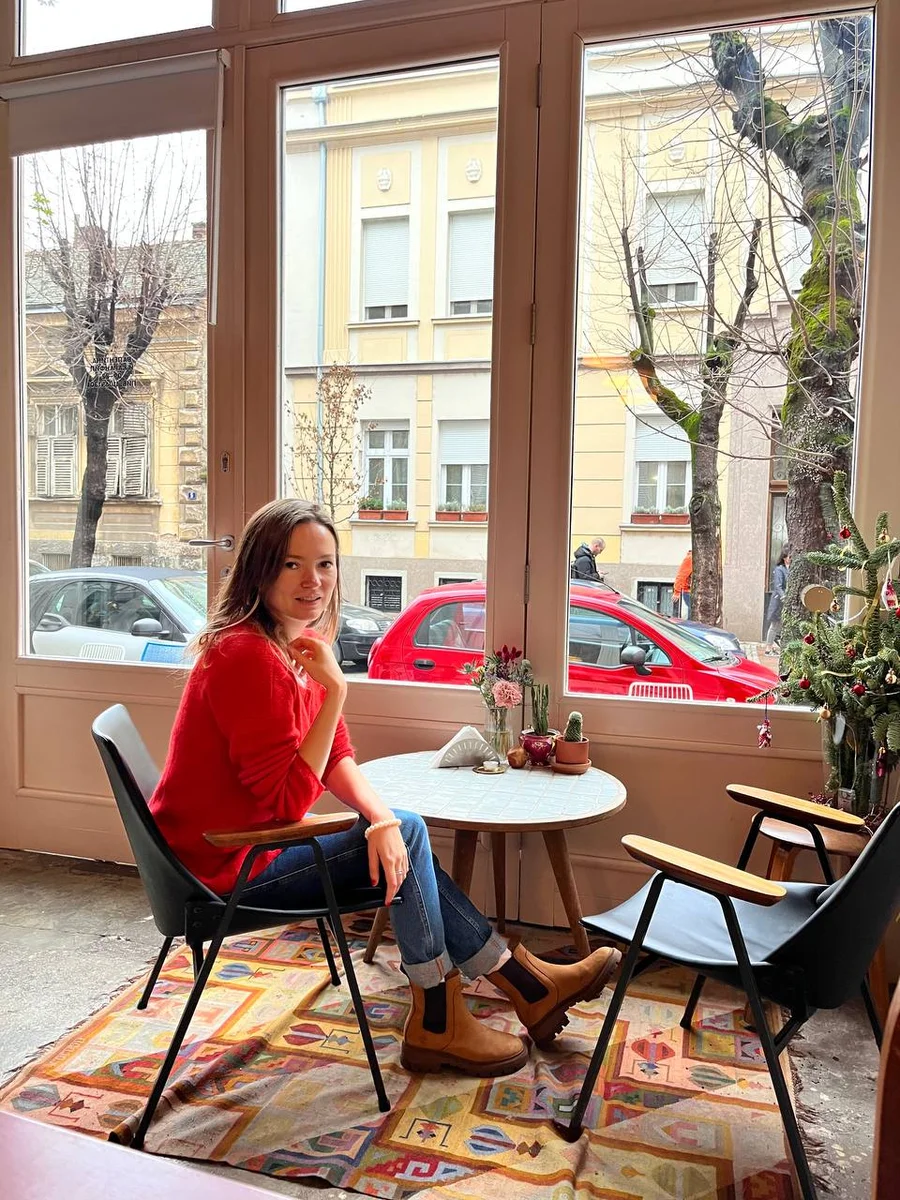 a girl sitting in a coffee shop 