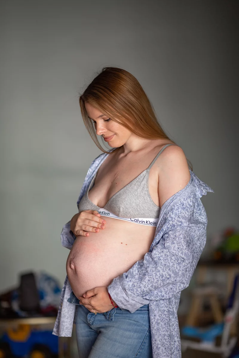 pregnant girl stroking her belly 