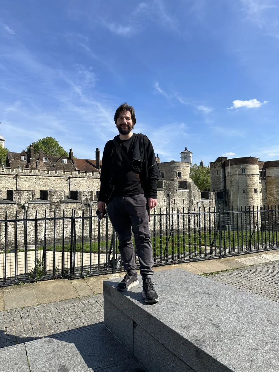 smiling man against the background of a landmark