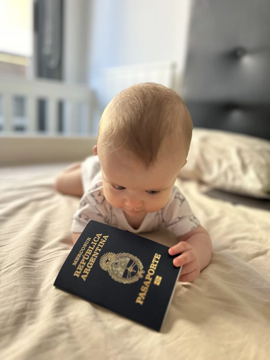 the baby is looking at Argentina's passport 